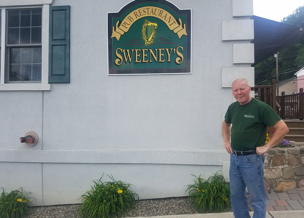 Sweeney’s Irish Pub owner Gary Sweeney stands in front of his restaurant. The pub remains open during the COVID-19 pandemic, which has forced many restaurants to close.